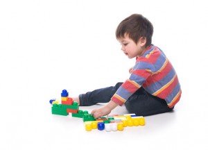 Boy with multicolored bricks